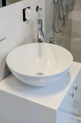 a white sink in a white bathroom at Downtown Apartments Cracow in Kraków