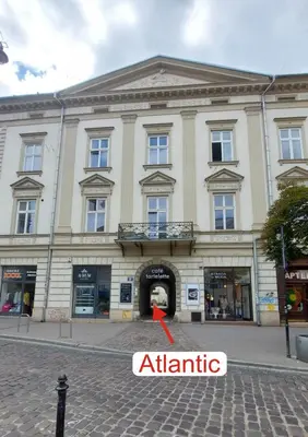a building with a red arrow in front of it at Atlantic Aparthotel in Kraków