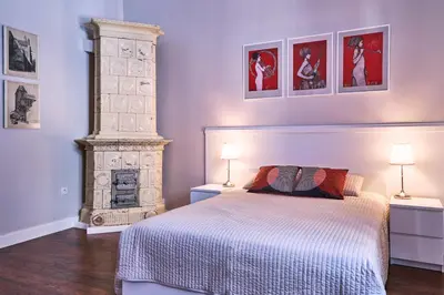 a bedroom with a bed and a fireplace at Kraków Old Town 2 bedroom royal apartment in Kraków