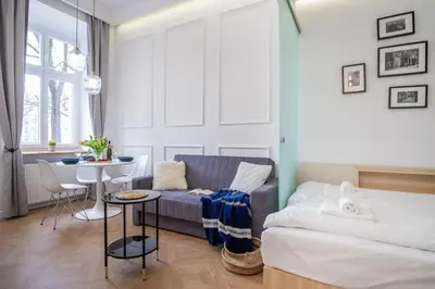 a living room with a couch and a table at MB Cracow Apartments in Kraków