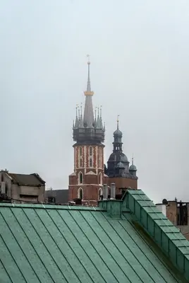 a building with two towers on top of a roof at MB Cracow Apartments in Kraków