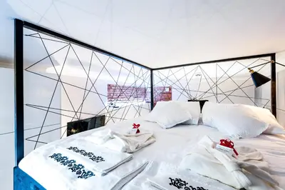 a bed with white pillows and towels on it at Home far from Home in Kraków