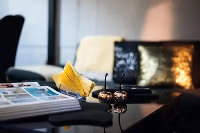 a coffee table with a book and a remote control at Home far from Home in Kraków