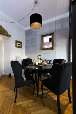 a dining room with a black table and chairs at Home far from Home in Kraków