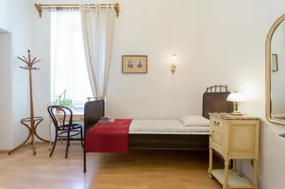 a bedroom with a bed and a mirror and a chair at Szeroka 33 D-F by Homeprime in Kraków