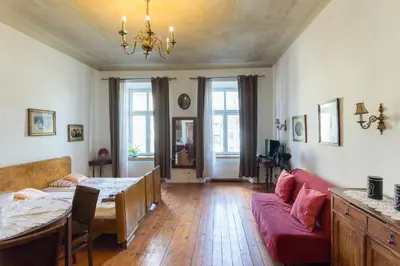 a living room with a table and a couch at Szeroka 33 D-F by Homeprime in Kraków