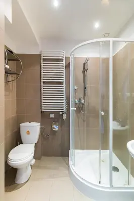 a bathroom with a shower and a toilet and a sink at Szeroka 33 D-F by Homeprime in Kraków