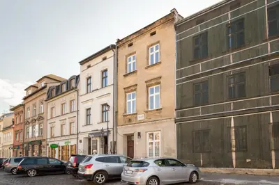a row of parked cars in front of buildings at Szeroka 33 D-F by Homeprime in Kraków