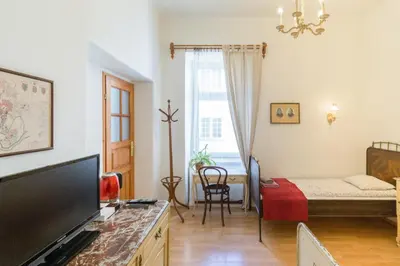 a living room with a tv and a bed in a room at Szeroka 33 D-F by Homeprime in Kraków
