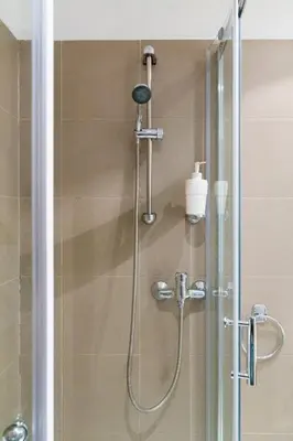a shower with a shower head in a bathroom at Szeroka 33 D-F by Homeprime in Kraków