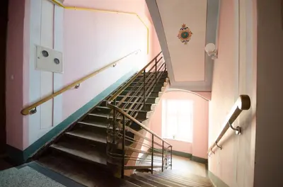 a spiral staircase in a building with a window at Fantasia Apartments in Kraków