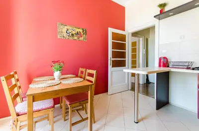 a kitchen and dining room with a table and chairs at Fantasia Apartments in Kraków