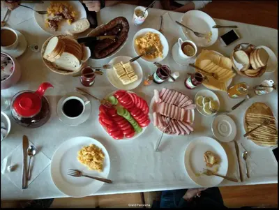 a table with plates of food on top at Grand Panorama in Wiśniowa