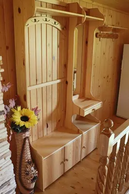 a room with a cabinet and a vase with a flower at Grand Panorama in Wiśniowa