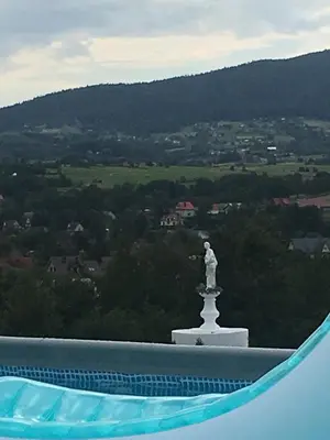 a statue on top of a building with a view at Grand Panorama in Wiśniowa