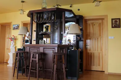 a bar in a room with stools around it at Grand Panorama in Wiśniowa