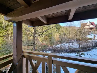 a view from the porch of a cabin with snow on the ground at Agroturystyka Oblica in Zawoja