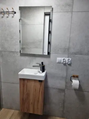 a bathroom with a sink and a mirror at Agroturystyka Oblica in Zawoja