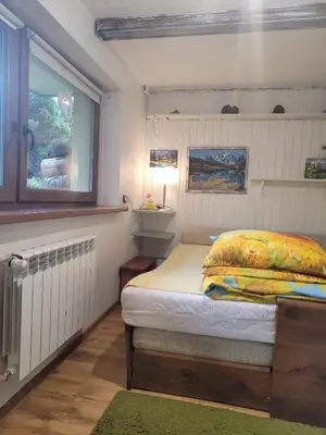 a small bedroom with a bed and a window at Agroturystyka Oblica in Zawoja