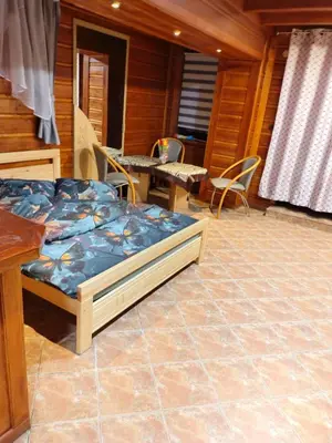 a bedroom with a bed and chairs and a table at Agroturystyka pod Pstragiem in Zawoja