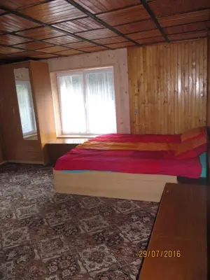 a bedroom with a bed and two windows at Agroturystyka pod Pstragiem in Zawoja