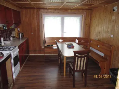 a kitchen with a table and chairs in a room at Agroturystyka pod Pstragiem in Zawoja