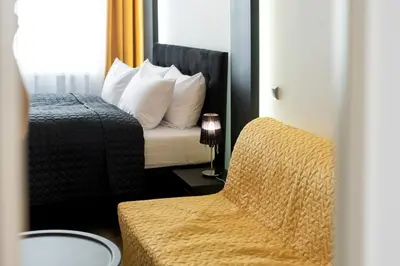 a bedroom with a large bed with two towels on it at Leo Apartments Old Town in Kraków