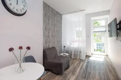 a living room with a black and white striped wall at Leo Apartments Old Town in Kraków