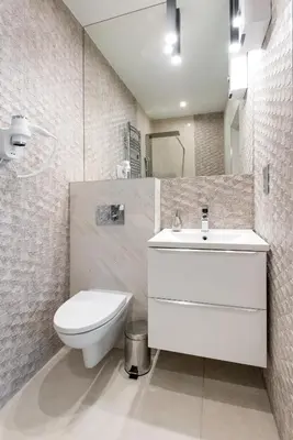 a white bathroom with a toilet and a sink at Leo Apartments Old Town in Kraków