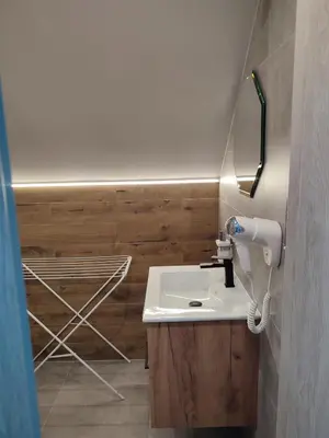 a bathroom with a sink and a drying rack at Willa Orle Gniazdo in Biały Kościół