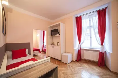 a hotel room with two beds and a mirror at Residence B&B La Fontaine Aparthotel in Kraków