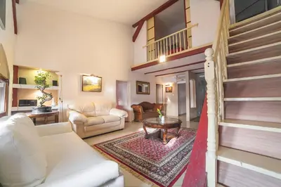 a bedroom with a pink bed with red pillows at Residence B&B La Fontaine Aparthotel in Kraków