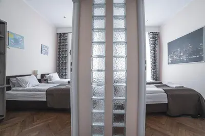 a living room with a table and a dining room at Residence B&B La Fontaine Aparthotel in Kraków