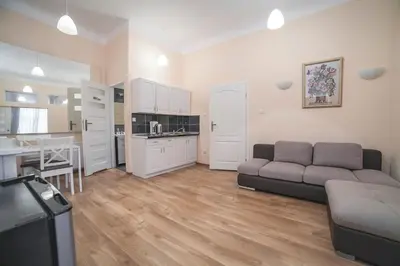 a bedroom with two beds and a window at Residence B&B La Fontaine Aparthotel in Kraków