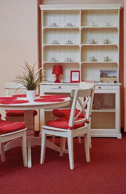 a dining room with a table and chairs and a shelf at Rembrandt Aparthotel in Kraków