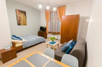 a living room with a couch and a bed at Central Krak Apartments - studios in Kraków