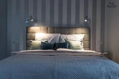 a bedroom with a large bed with pillows at Mateyko Apartment in Kraków