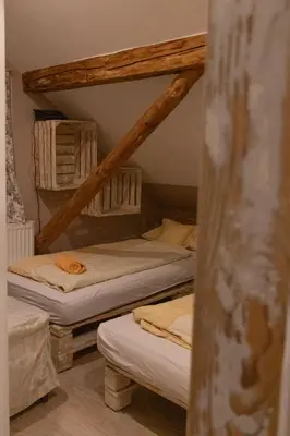 two bunk beds in a room with wooden beams at Agroturystyka Nad Jeziorem-Osada Indiańska in Czchów