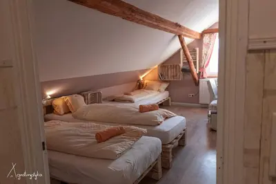 a bedroom with three beds in a attic at Agroturystyka Nad Jeziorem-Osada Indiańska in Czchów