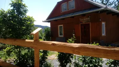 a wooden fence in front of a house at Agroturystyka Nad Jeziorem-Osada Indiańska in Czchów