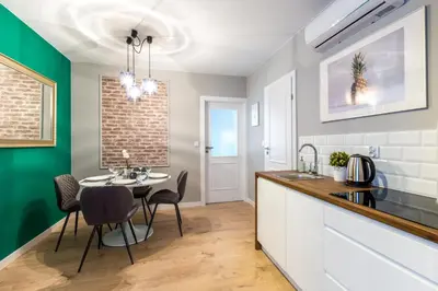 a dining room table and chairs in a kitchen at Friendhouse Apartments Vistula&Wawel in Kraków