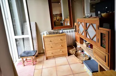 a room with a wooden dresser and a mirror at Apartament Krych in Rabka