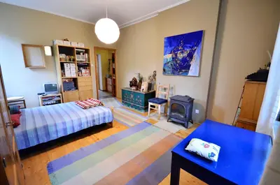 a bedroom with a bed and a stove in it at Apartament Krych in Rabka
