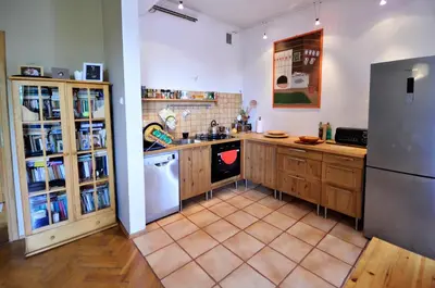 a kitchen with wooden cabinets and a stainless steel refrigerator at Apartament Krych in Rabka