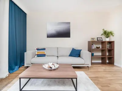 a living room with a couch and a table at Landmark Apartments in Kraków