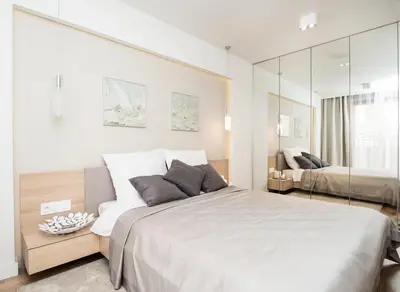 a bedroom with a large bed and a mirror at Landmark Apartments in Kraków
