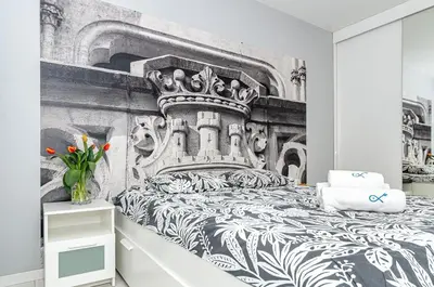 a bedroom with a bed with a crown on it at Landmark Apartments in Kraków