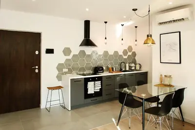 a kitchen with a table and a dining room at Cracovia in Kraków