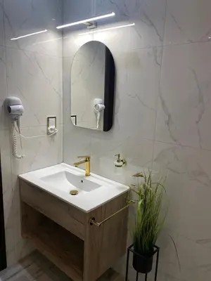a white bathroom with a sink and a mirror at Pokoje Bakos Radocza in Radocza