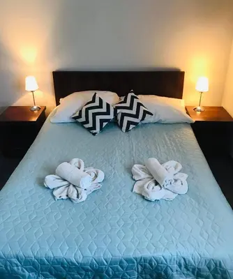 a bed with towels and pillows on it at Pokoje Bakos Radocza in Radocza